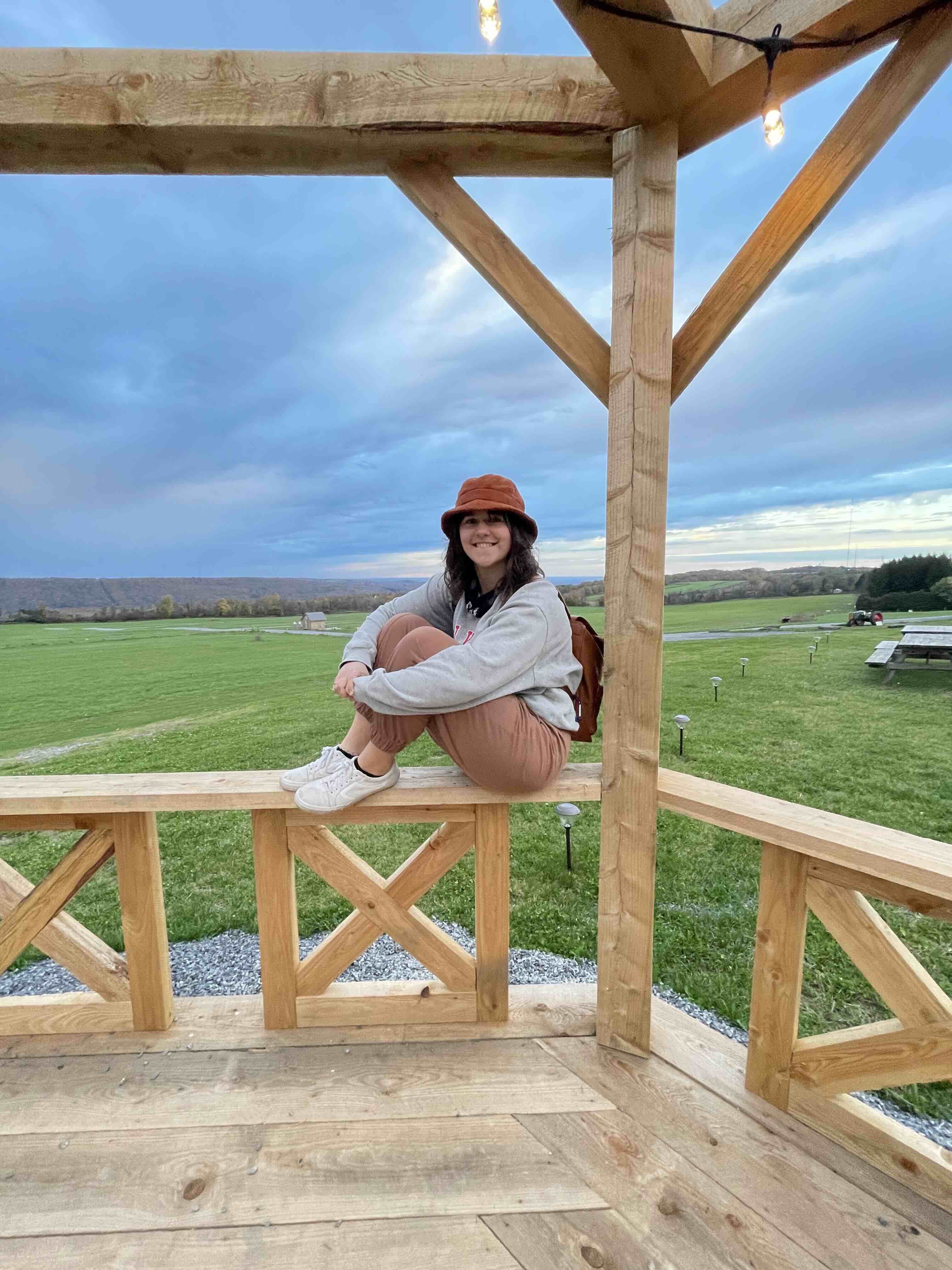 Lizzie Hill sitting on a railing