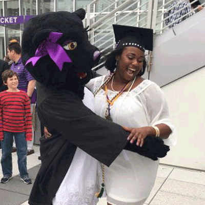 Candra posing with TK at graduation