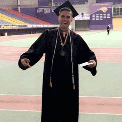 Matthew Klein in graduation cap and gown