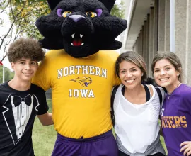 TC posing with a family on move-in day.