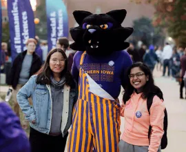 TC posing with students at homecoming festivities.