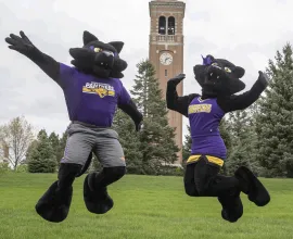 TC and TK jumping in front of the campanile.