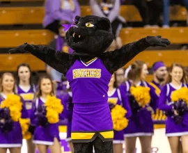 TK in front of cheerleaders in the McLeod Center.