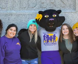 TK posing with students at homecoming festivities.